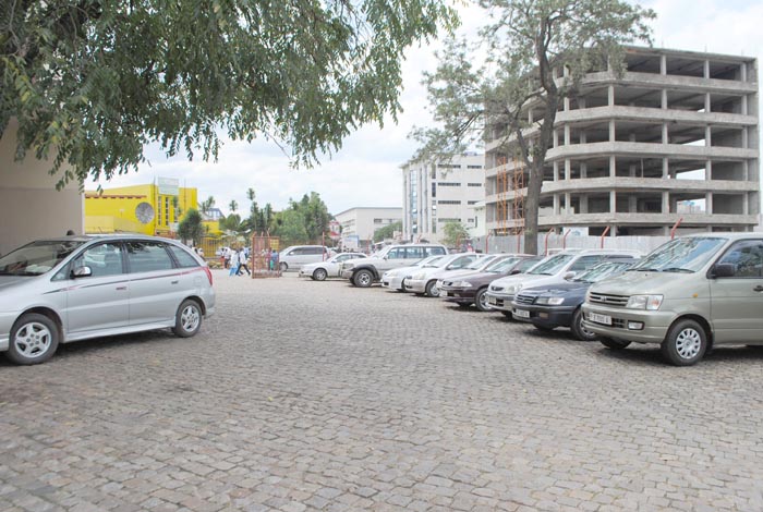 Cars in paid-parking space at “Palais des Arts. ©Iwacu