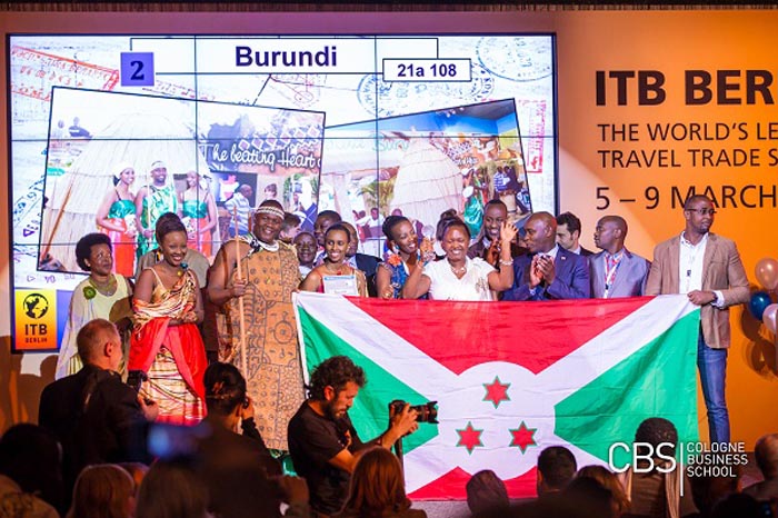 Burundian delegation exhibiting the national flag at Berlin International Show