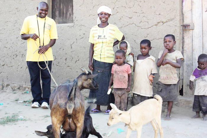 anvier Sibomana (left) and Jeanne Minani with her children standing near her goats donated by WHA  ©Iwacu
