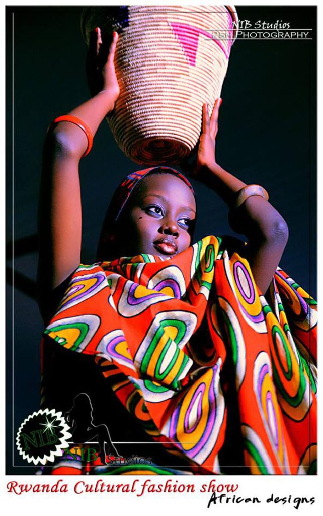 Vanessa Akintije modeling while using the Burundian traditional mill ©Iwacu