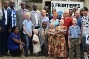 Family Picture of the governor of District 9.150 with Albinos who have just received school kit