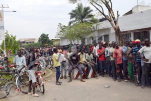 Bicycle taxi drivers queue up to buy the vests. 