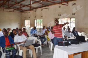 : Emile Niyungeko explaining the plan of screening activities to provincial health and administrative officials in Gatumba.