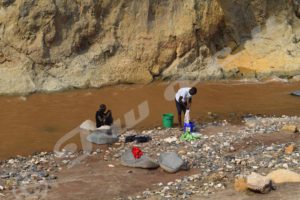 Mugoboka residents washing clothes in the Ntahangwa River