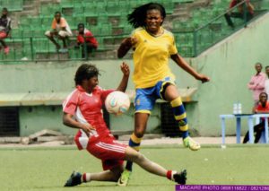 Emérence Girukwishaka, left, in red jersey, displaying her talent on the ground
