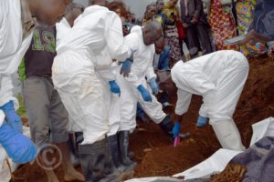 Experts excavating bones from a mass grave discovered in Gasenyi area