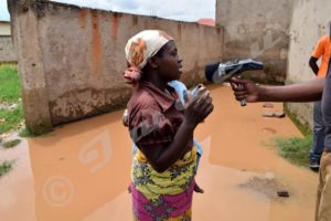 A woman whose home was inundated by the flood talks to journalists