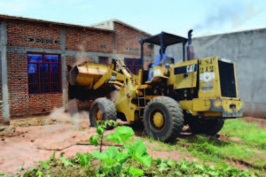 A bulldozer destroying one of the 23 houses in the perimeter where the occupants have to leave