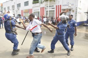 Police officers arresting a young person in  Bujumbura 