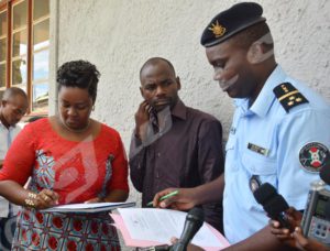 Pierre Nkurikiye, Spokesman for Burundi Police handing Antediteste Niragira, correspondent of Deutsche Welle over to Aimée Divine Niyokwizigirwa, Spokesperson for CNC