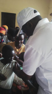 Dr Ndayishimiye Vianney giving a shot of MR vaccine 