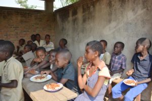 Pupils are having lunch in one of the school canteens in the country.