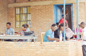 Registration agents writing the voters’ identity at “Gikungu I” registration center 