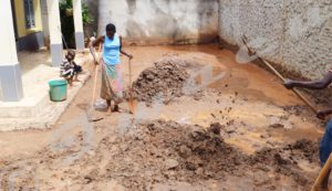 Residents of Carama trying to remove water and mud from their houses.