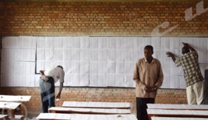 People searching for their names on the provisional lists at Lycée communal Musaga