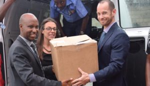 Alexis Manirakiza (right) receives the assistance from the US Embassy staff 