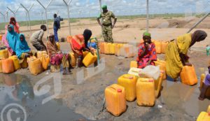 Displaced Somalis fetching water from taps installed by Burundian troops
