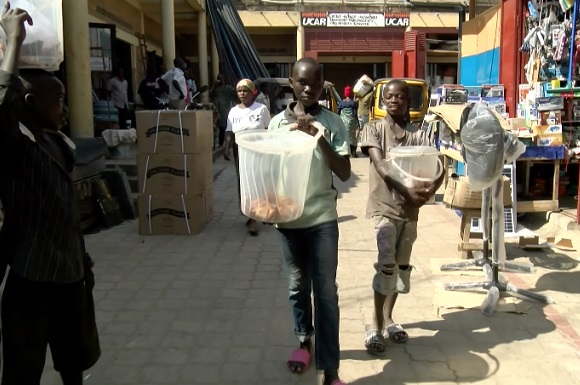 Children selling snacks at Buyenzi City Market