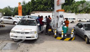 Gas pump attendant asks BIF 2400 per liter of gasoline 